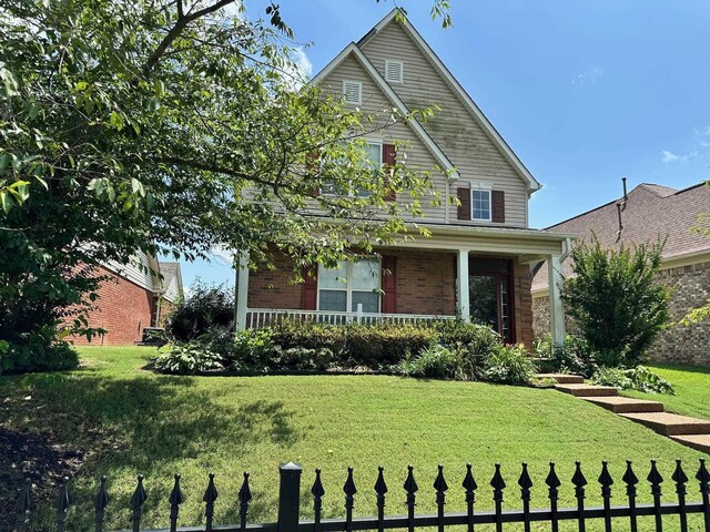 5489 Shipp Rd, Millington, TN 38053 - traditional-style house featuring brick siding and covered porch