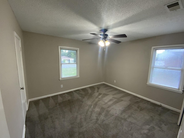 3560 Steele St, Memphis, TN 38127 - spare room featuring a ceiling fan, dark carpet, and a textured ceiling