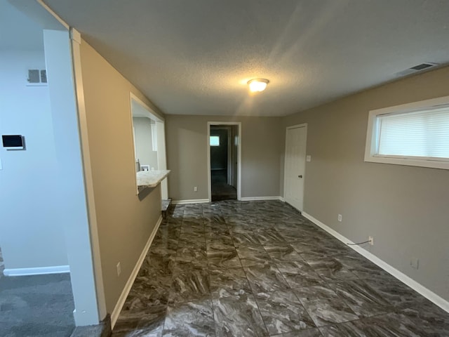 3560 Steele St, Memphis, TN 38127 - spare room featuring a textured ceiling and baseboards