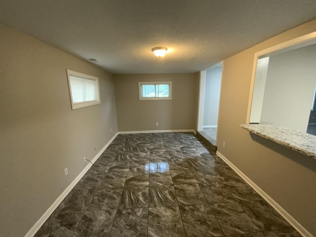 3560 Steele St, Memphis, TN 38127 - spare room with marble finish floors and a textured ceiling