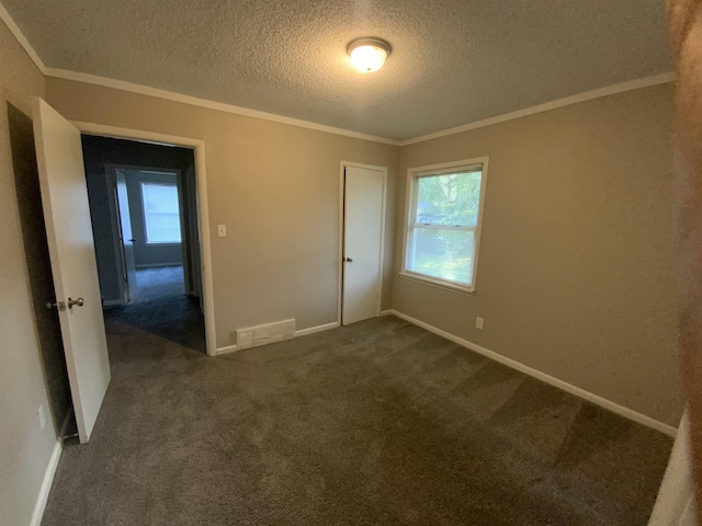 3560 Steele St, Memphis, TN 38127 - spare room featuring a textured ceiling, dark carpet, and crown molding