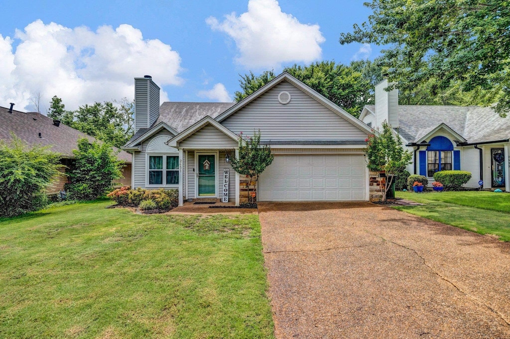 2651 Bay Pointe Cir W, Memphis, TN 38128 - single story home featuring a chimney, a garage, concrete driveway, and a front lawn
