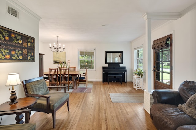 4152 Barfield Rd, Memphis, TN 38117 - living area with light wood finished floors, a chandelier, plenty of natural light, and crown molding