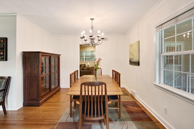 4152 Barfield Rd, Memphis, TN 38117 - dining room with a chandelier, wood finished floors, crown molding, and plenty of natural light