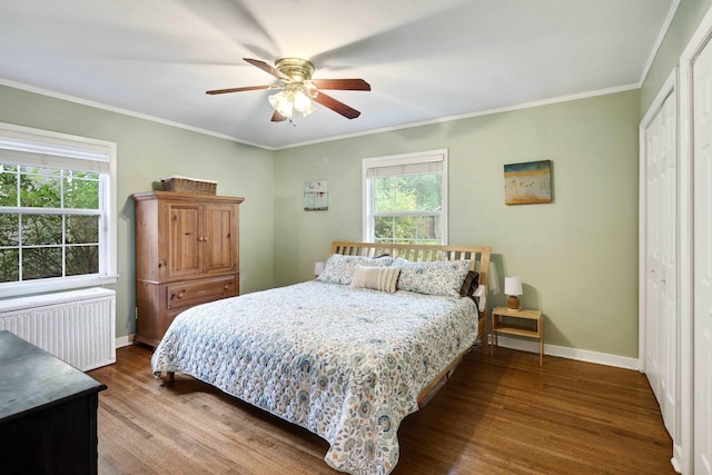 4152 Barfield Rd, Memphis, TN 38117 - bedroom featuring radiator heating unit, wood finished floors, a closet, crown molding, and a ceiling fan