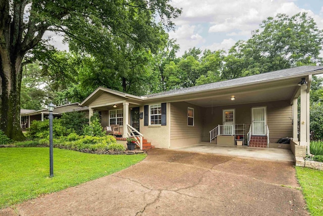 4152 Barfield Rd, Memphis, TN 38117 - single story home with concrete driveway, a porch, a front yard, an attached carport, and brick siding