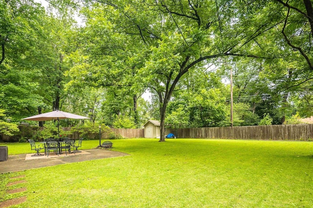 4152 Barfield Rd, Memphis, TN 38117 - fenced backyard with a storage unit and a patio area