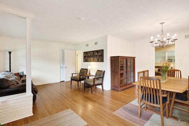 4152 Barfield Rd, Memphis, TN 38117 - dining area featuring light wood finished floors, a chandelier, and ornamental molding