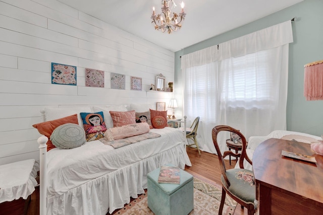 560 S Greer St, Memphis, TN 38111 - bedroom with a chandelier, wood finished floors, and wooden walls