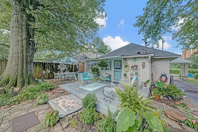560 S Greer St, Memphis, TN 38111 - back of house with a wooden deck, a fenced backyard, outdoor dining area, and a shingled roof