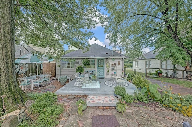 560 S Greer St, Memphis, TN 38111 - back of property featuring outdoor dining area, a wooden deck, and a shingled roof