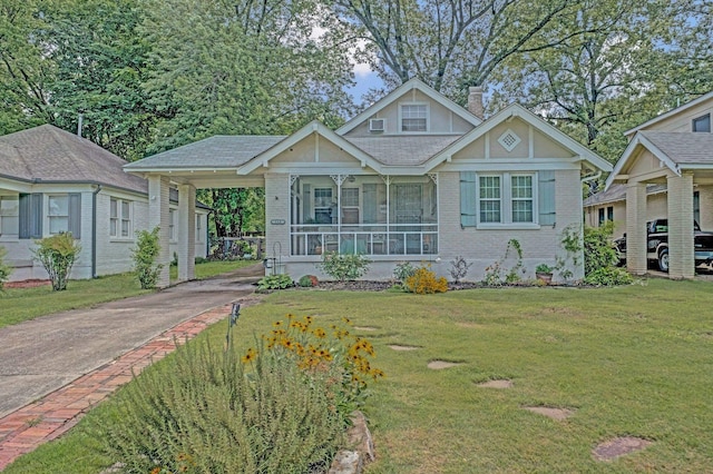 560 S Greer St, Memphis, TN 38111 - view of front facade with concrete driveway, a front lawn, a chimney, brick siding, and an attached carport