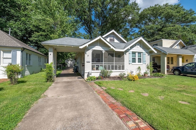 560 S Greer St, Memphis, TN 38111 - view of front facade with driveway, brick siding, a front yard, and an attached carport