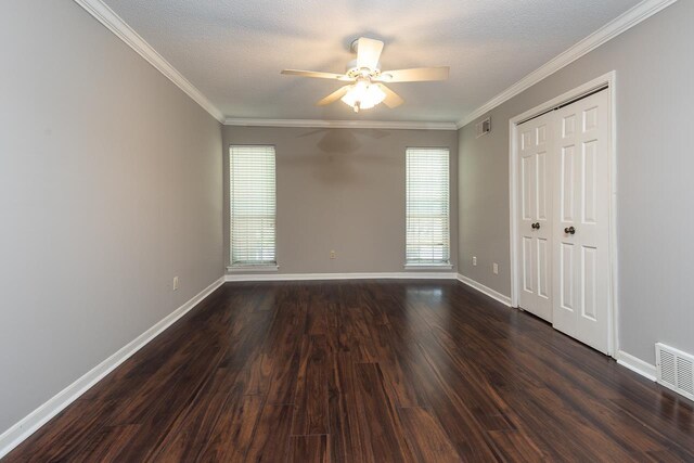 6942 Amberly Rd Unit 6942, Memphis, TN 38119 - unfurnished bedroom featuring dark wood-style floors, crown molding, a closet, ceiling fan, and a textured ceiling