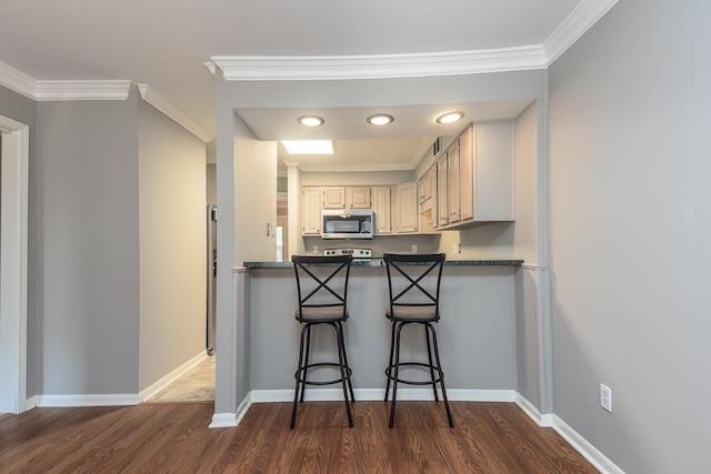6942 Amberly Rd Unit 6942, Memphis, TN 38119 - kitchen with stainless steel microwave, dark wood-type flooring, crown molding, dark countertops, and a breakfast bar