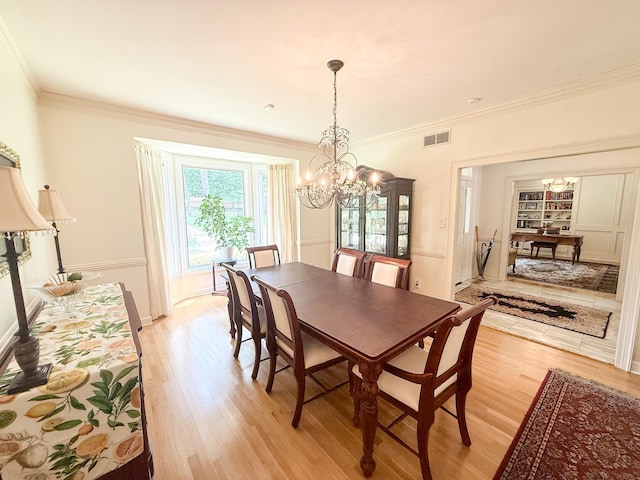 78 Pidgeon Dr, Memphis, TN 38117 - dining area featuring a chandelier, light wood-style flooring, and ornamental molding