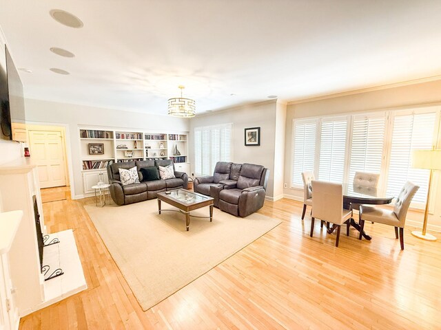 78 Pidgeon Dr, Memphis, TN 38117 - living room featuring a chandelier, light wood-type flooring, ornamental molding, and built in features