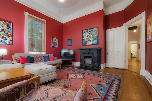 1785 Glenwood Pl, Memphis, TN 38104 - living room featuring a wood stove, wood finished floors, and a ceiling fan