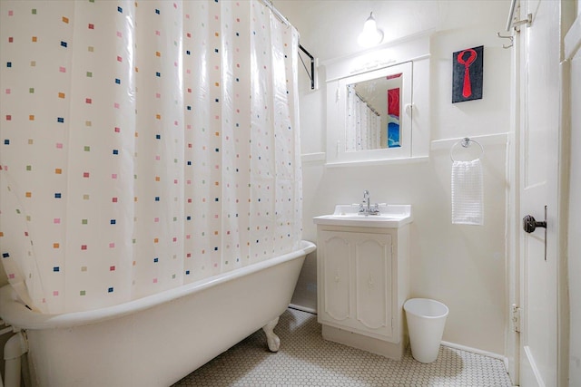 1785 Glenwood Pl, Memphis, TN 38104 - bathroom with a freestanding bath, vanity, tile patterned floors, and a shower with curtain