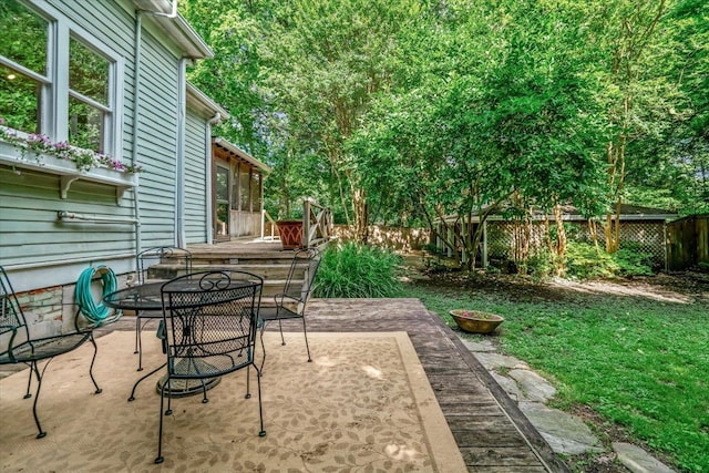 1785 Glenwood Pl, Memphis, TN 38104 - fenced backyard with outdoor dining space, a sunroom, and a patio