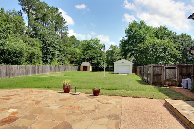 1150 Forest Wood Cv E, Collierville, TN 38017 - fenced backyard with a storage shed, a patio area, and a detached garage