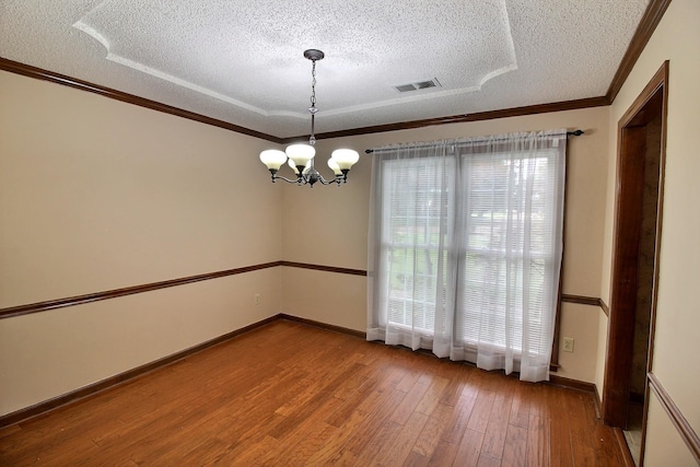 1150 Forest Wood Cv E, Collierville, TN 38017 - unfurnished room with a textured ceiling, a chandelier, hardwood / wood-style floors, and ornamental molding
