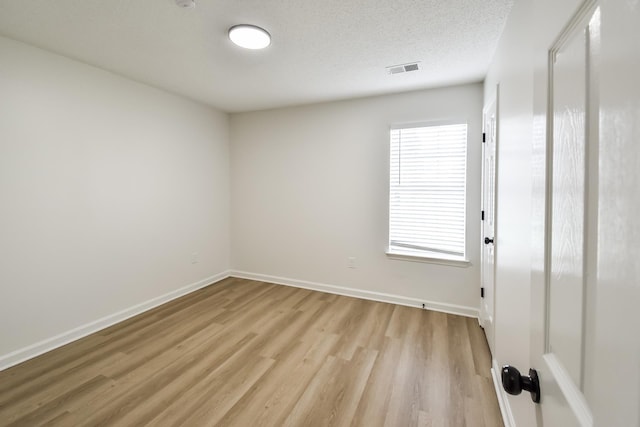 7881 Collins Wood Cv, Memphis, TN 38125 - spare room featuring light wood-style floors and a textured ceiling