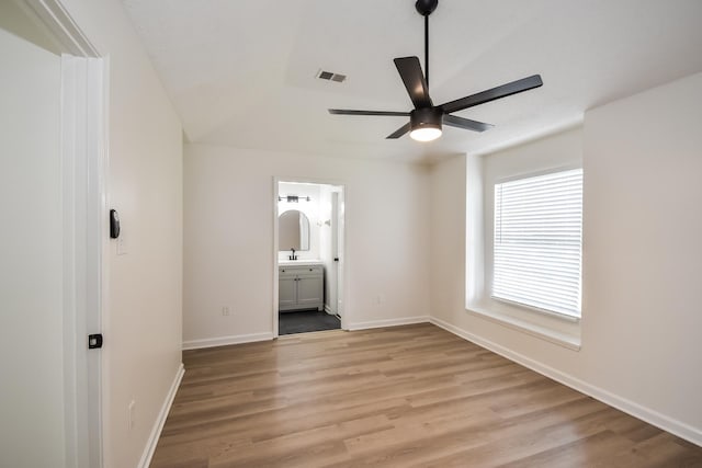 7881 Collins Wood Cv, Memphis, TN 38125 - unfurnished bedroom featuring light wood-type flooring, ensuite bath, and ceiling fan