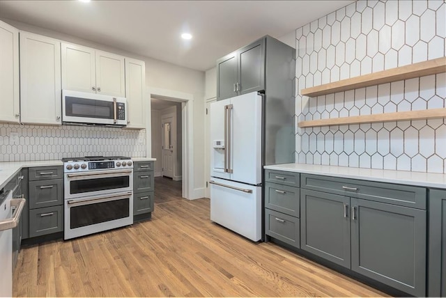 1622 Tutwiler Ave, Memphis, TN 38107 - kitchen featuring range with two ovens, white refrigerator with ice dispenser, gray cabinetry, and recessed lighting
