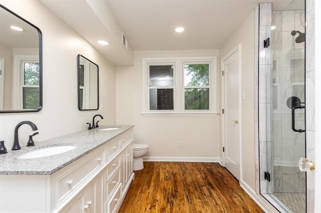 1622 Tutwiler Ave, Memphis, TN 38107 - bathroom featuring double vanity, a shower stall, wood finished floors, and recessed lighting