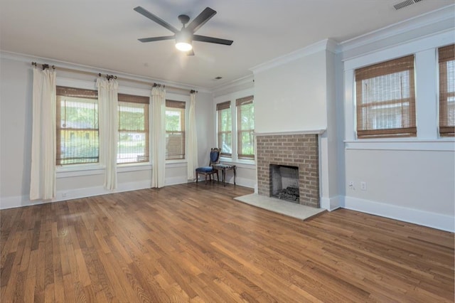 1622 Tutwiler Ave, Memphis, TN 38107 - unfurnished living room featuring wood finished floors, crown molding, ceiling fan, and a fireplace