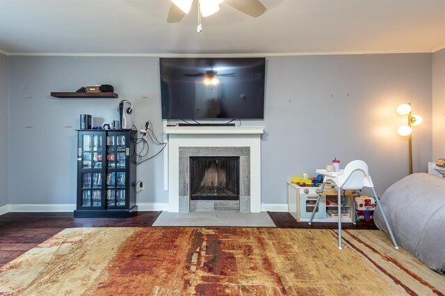 1622 Tutwiler Ave, Memphis, TN 38107 - living area featuring a ceiling fan, ornamental molding, wood finished floors, and a fireplace