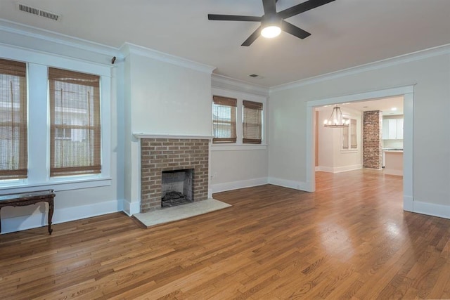 1622 Tutwiler Ave, Memphis, TN 38107 - unfurnished living room featuring a chandelier, a fireplace, a ceiling fan, ornamental molding, and wood finished floors