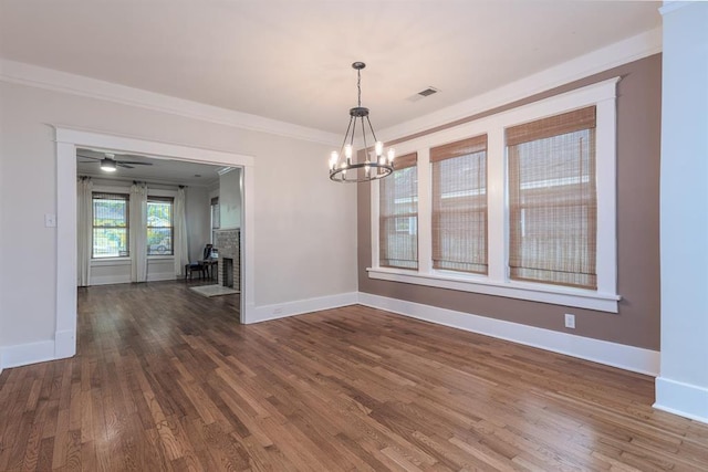 1622 Tutwiler Ave, Memphis, TN 38107 - unfurnished dining area with dark wood finished floors, a chandelier, and crown molding