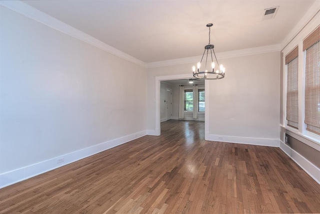 1622 Tutwiler Ave, Memphis, TN 38107 - empty room featuring a chandelier, dark wood-type flooring, and ornamental molding