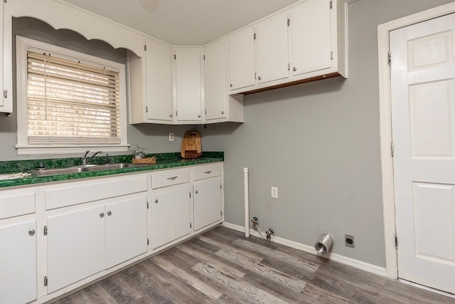 3806 Bluff Rd, Hernando, MS 38632 - washroom with wood finished floors, cabinet space, hookup for a gas dryer, and hookup for an electric dryer