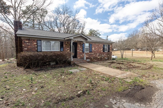 3806 Bluff Rd, Hernando, MS 38632 - ranch-style house with a chimney, brick siding, and roof with shingles