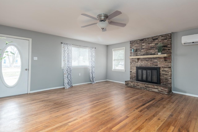 3806 Bluff Rd, Hernando, MS 38632 - unfurnished living room featuring healthy amount of natural light, a wall mounted air conditioner, wood finished floors, and ceiling fan
