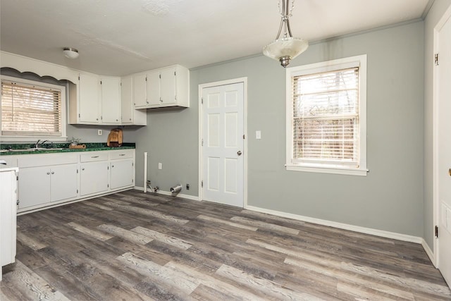 3806 Bluff Rd, Hernando, MS 38632 - kitchen with white cabinets, dark wood-type flooring, dark countertops, ornamental molding, and hanging light fixtures