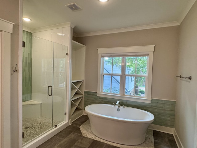 7148 Donnington Dr, Germantown, TN 38138 - bathroom with a stall shower, a freestanding tub, crown molding, tile walls, and wainscoting