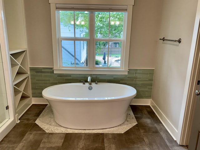 7148 Donnington Dr, Germantown, TN 38138 - bathroom with a freestanding tub, tile walls, and a wainscoted wall