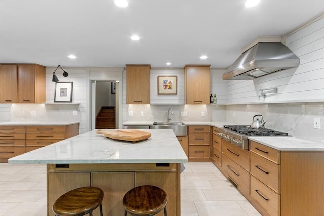 9240 Riveredge Dr, Memphis, TN 38018 - kitchen featuring island range hood, tasteful backsplash, stainless steel gas cooktop, a kitchen bar, and light stone counters