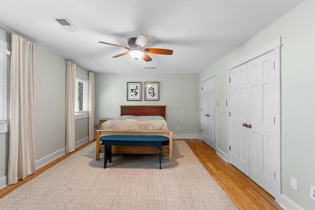 9240 Riveredge Dr, Memphis, TN 38018 - bedroom with light wood-style flooring, two closets, and ceiling fan