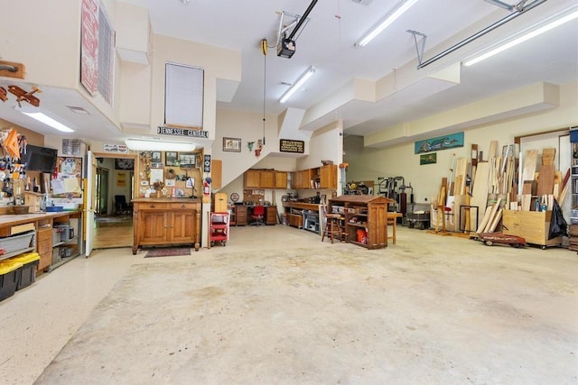 9240 Riveredge Dr, Memphis, TN 38018 - garage featuring a workshop area and a garage door opener