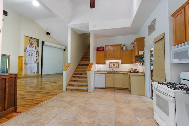 9240 Riveredge Dr, Memphis, TN 38018 - kitchen with white appliances, vaulted ceiling, and light wood-type flooring