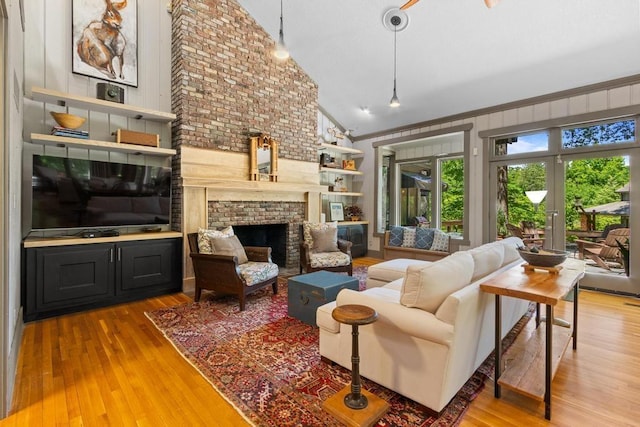 9240 Riveredge Dr, Memphis, TN 38018 - living room with vaulted ceiling, wood finished floors, a fireplace, and ornamental molding