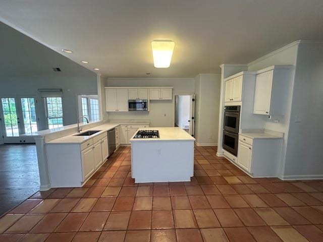 6425 Lebarrett Cv, Memphis, TN 38120 - kitchen with stainless steel appliances, tile patterned floors, white cabinets, light countertops, and recessed lighting
