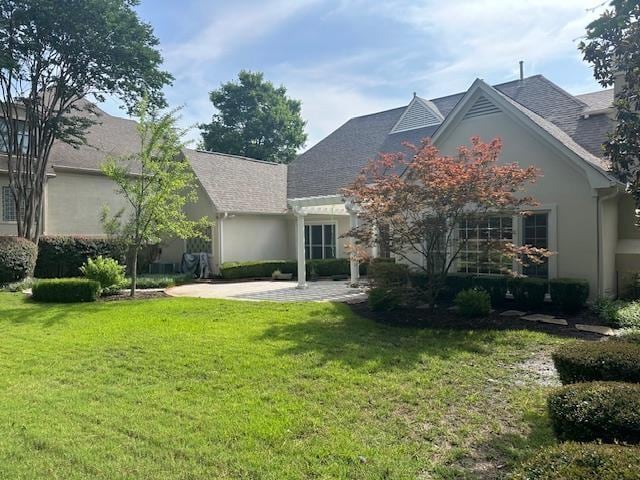 6425 Lebarrett Cv, Memphis, TN 38120 - rear view of property with a yard, a patio, stucco siding, and roof with shingles