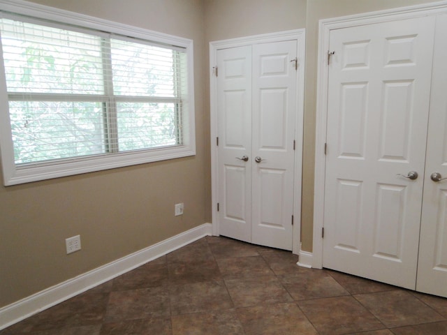 630 Ridgecrest Dr, Pope, MS 38658 - unfurnished bedroom featuring baseboards and dark tile patterned flooring
