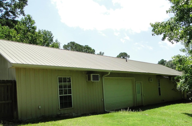 630 Ridgecrest Dr, Pope, MS 38658 - view of home's exterior with a metal roof, a garage, and an AC wall unit